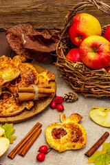 Homemade apple dessert, portioned puffs with fragrant cinnamon sticks, colorful foliage, autumn good mood