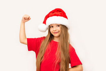 A little girl in a Christmas hat shows her strength.
