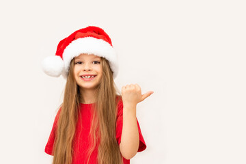 A little girl posing in a Christmas hat.