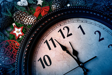 New Year's clock shows five to midnight and decorations.