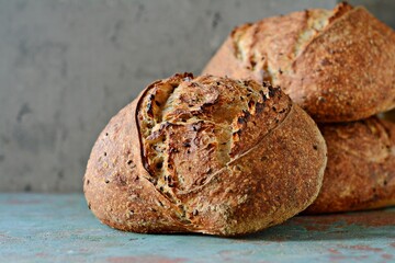 Homemade Freshly Baked Country Bread  made from wheat and whole grain flour on gray background. French Freshly baked bread. 