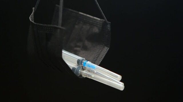 footage of mask syringe dark background 
