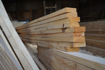 Wooden braces to build a roof. Materials for sale within a sawmill. Wood industry. Production factory.