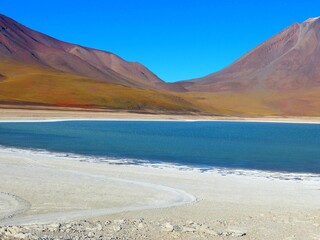Unique mineral lake Laguna with tranquil deep blue surface  Verde among Andes volcanic mountains,...