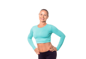 Smiling adult athletic woman in sportswear with good abs and hands on hips, isolated on white. Caucasian model promotes healthy lifestyle, fitness services and products.