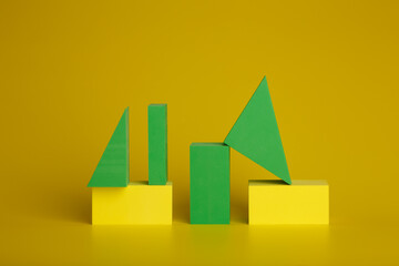 Green and yellow geometrical figures on yellow background