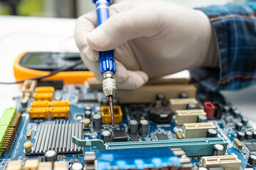 technician repairing inside of hard disk by soldering iron. Integrated Circuit. the concept of...