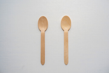 Close-up wooden spoon isolated yellow background