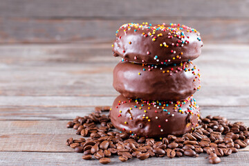 Yummy donuts with sprinkles on table. Space for text