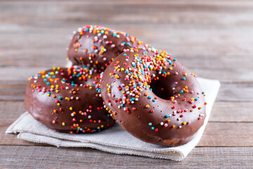Baked chocolate doughnuts with chocolate glaze on a table