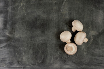 Mushrooms on a dark wooden background.