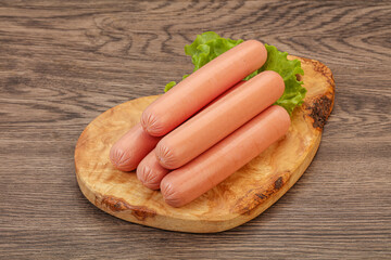 Tasty meat sausages over board