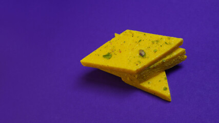 Kaju katli on purple background, Indian festival diwali mithai background.