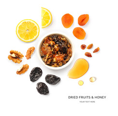 Creative layout made of dried fruits, nuts, honey and lemon on a white background. Top view.  