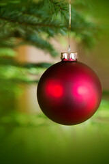 Christmas ball isolated on green bokeh holiday light background