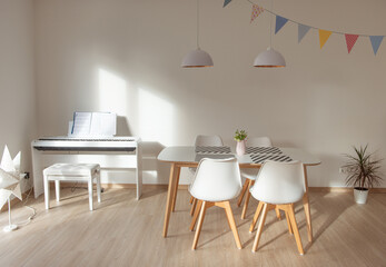 Modern interior with white eating table and e-piano