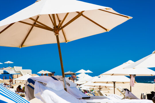 Low angle view,sunbeds and sun umbrellas on a beach,blue sky background