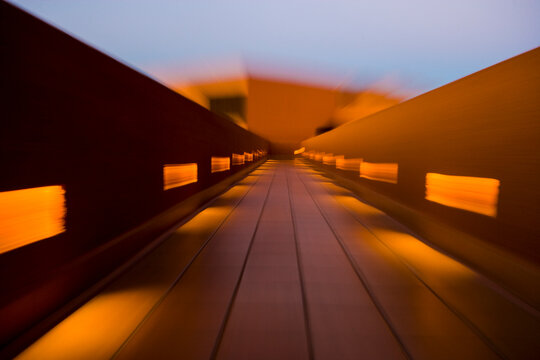 Motion blur,a colorful walkway with balustrade and patches of sunlight.