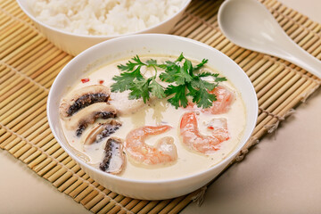 Close-up Tom Yam soup.Traditional asian thai food. Healthy and tasty soup with rice, coconut milk, shrimps and mushrooms.