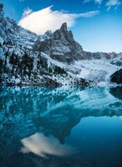 Fototapeta na wymiar Lago di Sorapis lake, Dolomite Alps, Italy. Beautiful natural landscape at the winter time. Reflections on water surface.