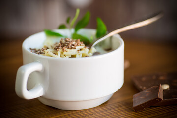 sweet noodles with milk and grated chocolate in a bowl