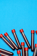 top view of medicine test tubes with blood samples over blue background