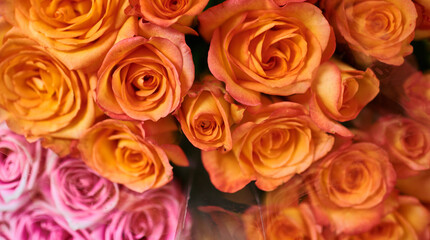 Beautiful bouquets of red, pink and yellow roses in a flower shop. A bright mix of flowers. Handsome fresh bouquets. Flowers delivery. Floral shop concept. Selective focus.