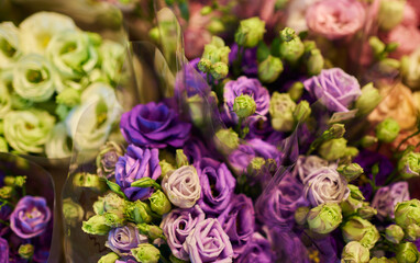 Beautiful bouquets of mixed flowers in a flower shop. A bright mix of flowers. Background on full screen. Handsome fresh bouquets. Flowers delivery. Floral shop concept. Selective focus.