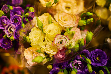 Beautiful bouquets of mixed flowers in a flower shop. A bright mix of flowers. Background on full screen. Handsome fresh bouquets. Flowers delivery. Floral shop concept. Selective focus.
