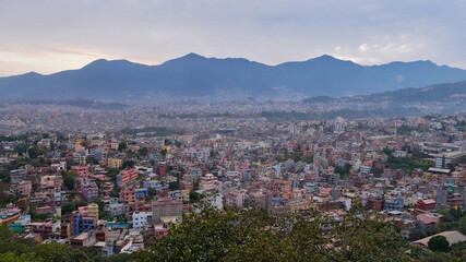 Fototapeta na wymiar Panorama view over the west of densely populated Kathmandu, Nepal with Himalaya foothills (Chandragiri Hills) in background viewed from historic Buddhist temple complex Swayambhunath.