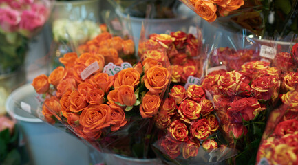 Beautiful bouquets of red, pink and yellow roses in a flower shop. A bright mix of flowers. Handsome fresh bouquets. Flowers delivery. Floral shop concept