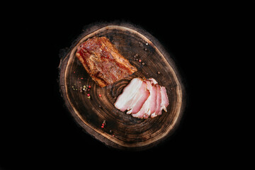 Smoked bacon fragrant juicy, on a wooden board. Top view.