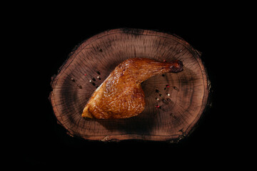Smoked Chicken thigh fragrant juicy, on a wooden board. Top view.