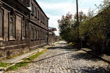 Fototapeta na wymiar Old street with wooden houses and stone road in Gyumri, Armenia