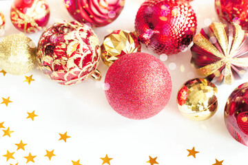 red and golden Christmas balloons close-up on a white background. Christmas background with Christmas toys. snowflakes and balloons close-up on a white holiday background.