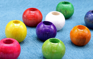 colorful wooden beads on a blue background
