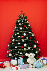 Fototapeta na wymiar Christmas interior Christmas tree holiday red decor presents new year