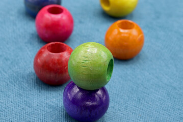 colorful wooden beads on a blue background
