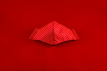 Home-made face mask on a red background, covid -19, Coronavirus