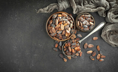 Cocoa beans on old background