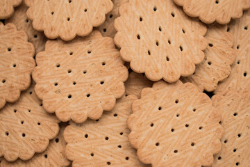Close up of many little cookies on a black wooden table  