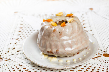 Christmas cake kuglof with white glaze topping, beautifully decorated red green nutcracker