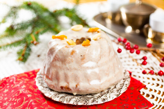 Christmas cake kuglof with white glaze topping, beautifully decorated red green nutcracker