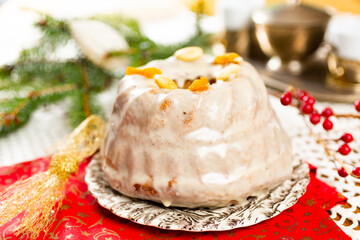 Christmas cake kuglof with white glaze topping, beautifully decorated red green nutcracker