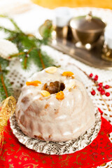 Christmas cake kuglof with white glaze topping, beautifully decorated red green nutcracker