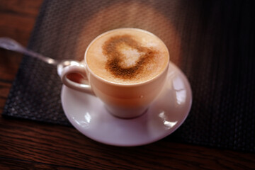 Photo of delicious coffee with a heart pattern cappuccino