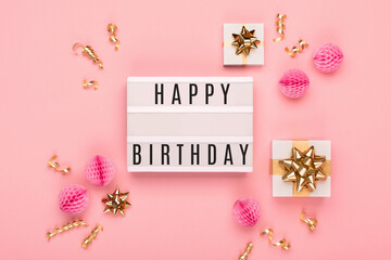 Empty white Lightbox with festive gift boxes, golden and pink decorations on amaranth pink paper background.