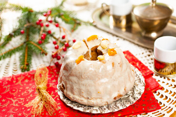 Christmas cake kuglof with white glaze topping, beautifully decorated red green nutcracker