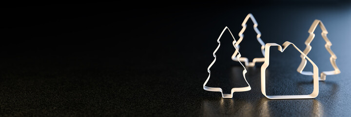 Christmas real estate concept: A house shaped cookie cutter and three Christmas Tree cookie cutters...