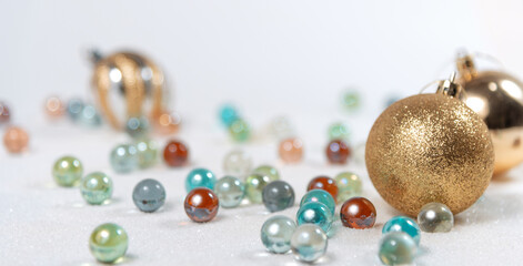 glass and Christmas balls on a white background